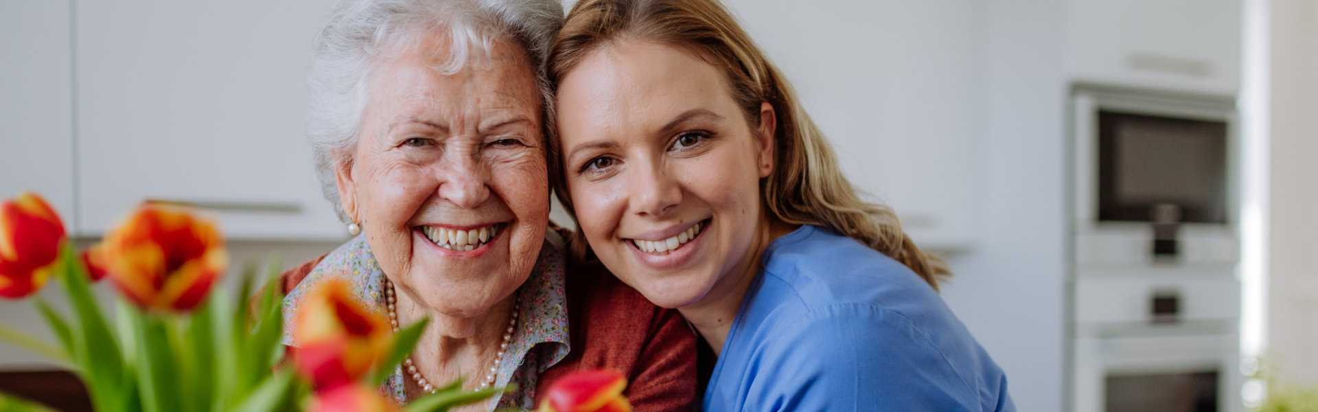 Caregiver hugging elderly